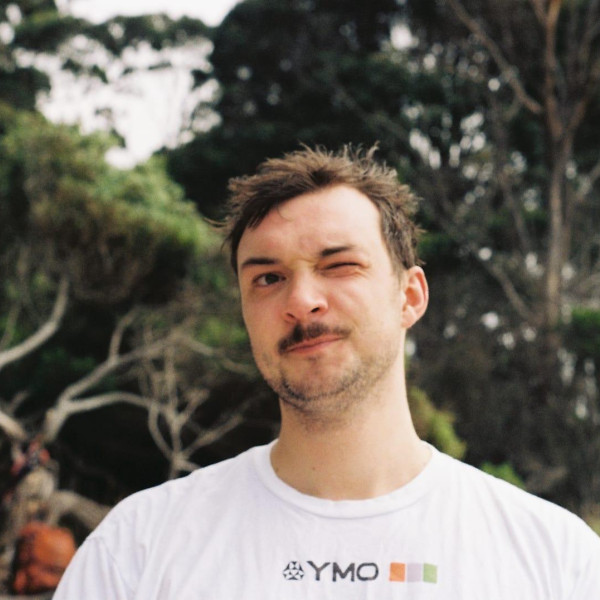 DJ Jamie Pettinger winks with his left eye, looking directly at the camera.