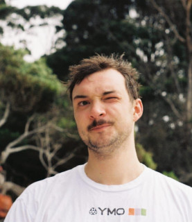DJ Jamie Pettinger winks with his left eye, looking directly at the camera.