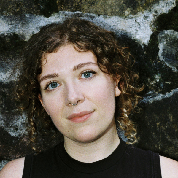 DJ Rowan McIlvride looks directly at the camera with a tilted head.