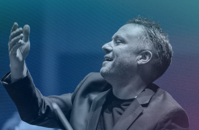 Colin Currie smiles as he conducts