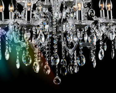 A diamond-like chandelier hangs down with a prism of colour shining from it.