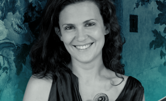 Lorenza Borrani smiles at the camera, holding her violin
