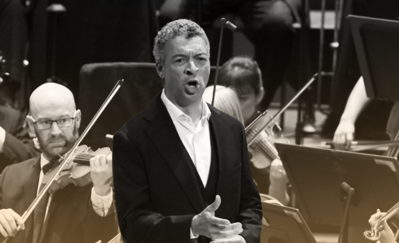 Roderick Williams sings at the Proms with the Orchestra playing behind.