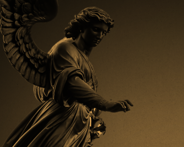 An angel statue with a golden hue.