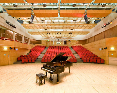 Stevenson Hall auditorium, photographed from the back of the stage on which there is a grand piano.