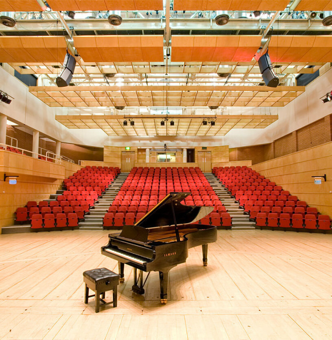 Stevenson Hall auditorium, photographed from the back of the stage on which there is a grand piano.