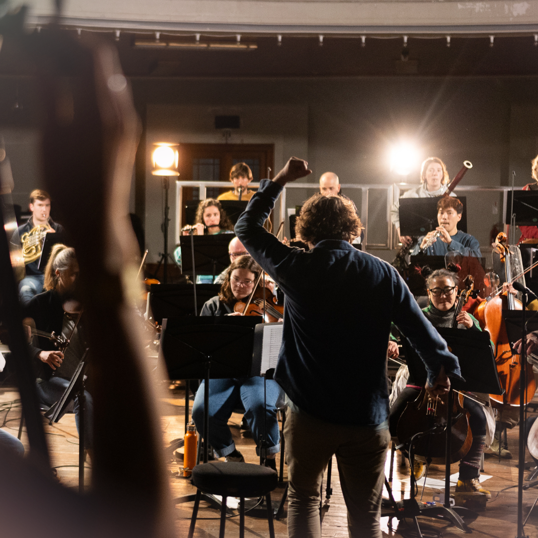 Image with Maxim conducting with cameras around