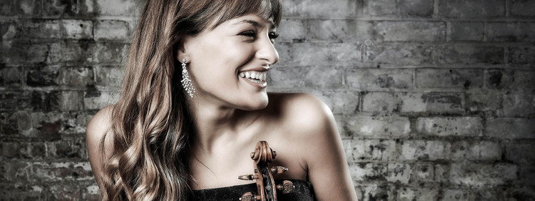 Nicola Benedetti holding her violin laughing