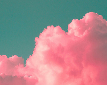 A photograph of pink clouds and a blue sky.