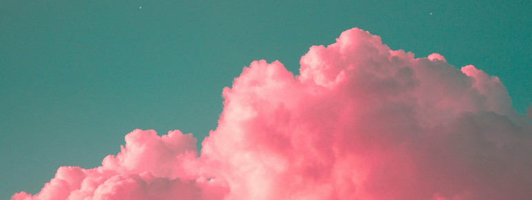 A photograph of pink clouds and a blue sky.