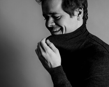 Grosvenor laughing in a jumper