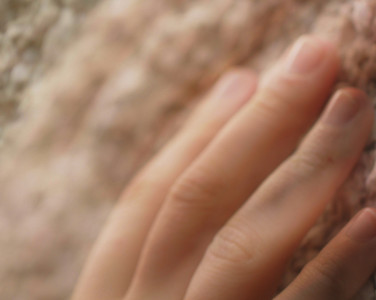 An image of a hand on a white wall