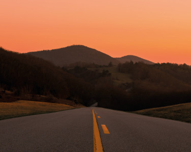 An american highway with the sunset in the background