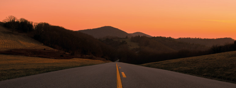 An american highway with the sunset in the background